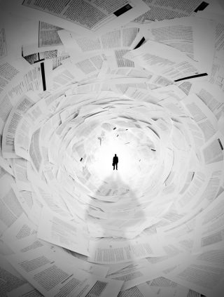 Silhouette of businessman in the end of documents tunnel